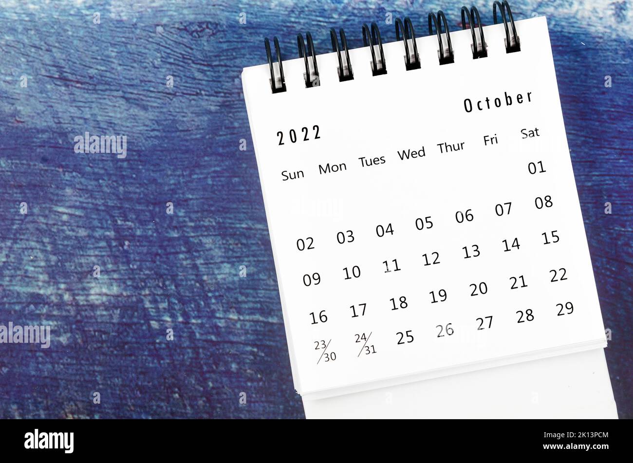 October 2022 Monthly desk calendar for 2022 year on old blue wooden background. Stock Photo