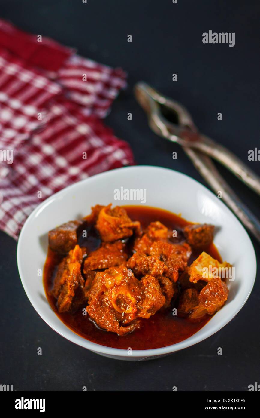 selective focus of delicious Indian style mutton curry with a decorative background. Stock Photo