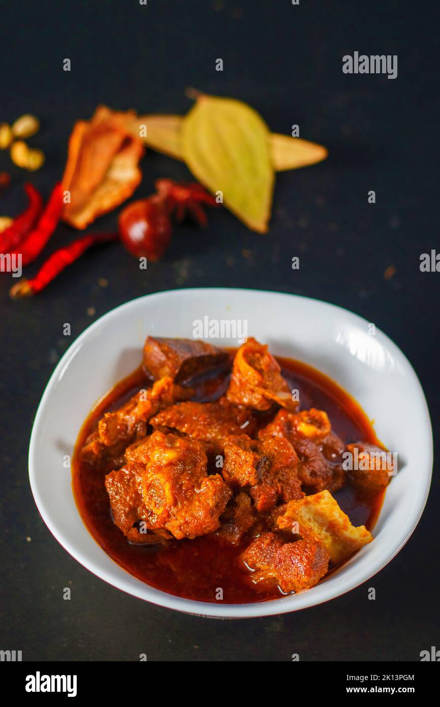 selective focus of delicious Indian style mutton curry with a decorative background. Stock Photo