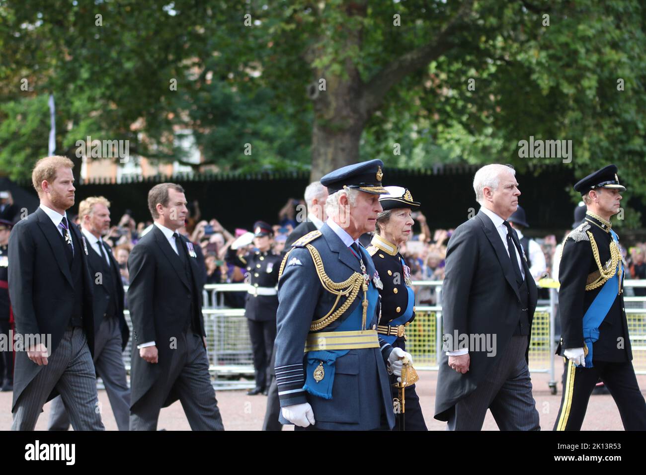 Prince Harry, Peter Phillips, King Charles the 3rd, Princess Anne, Prince Andrew and Prince Edward march behind as Queen Elizabeth the second is carried on a gun carriage from Buckingham Palace to Westminster Hall down the Mall, covered by the Royal Standard flag and the Imperial State Crown. Stock Photo