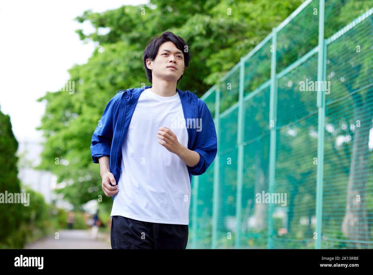 Japanese man running outside Stock Photo