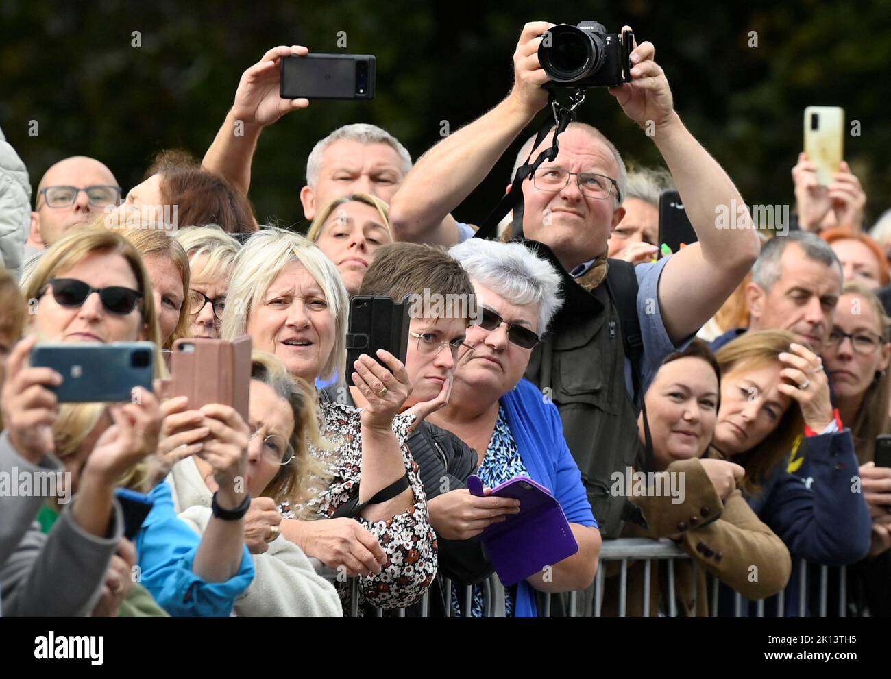 Wellwishers take pictures of the Prince and Princess of Wales as they view floral tributes at the gates of Sandringham House in Norfolk, following the death of Queen Elizabeth II. Picture date: Thursday September 15, 2022. Stock Photo