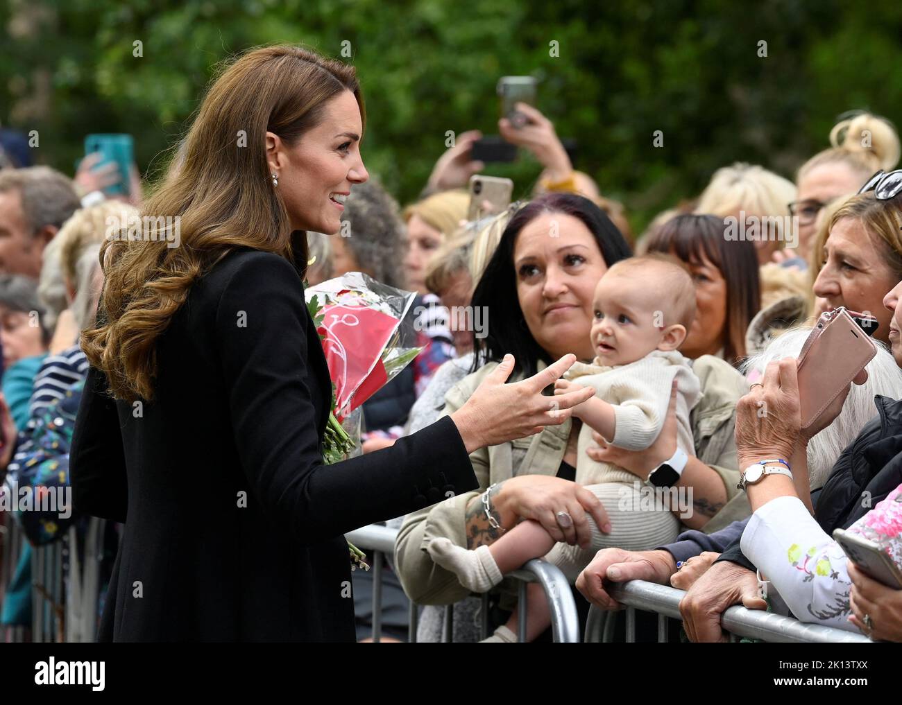 The Princess of Wales meeting wellwishers as she views floral tributes left by members of the public at the gates of Sandringham House in Norfolk, following the death of Queen Elizabeth II. Picture date: Thursday September 15, 2022. Stock Photo