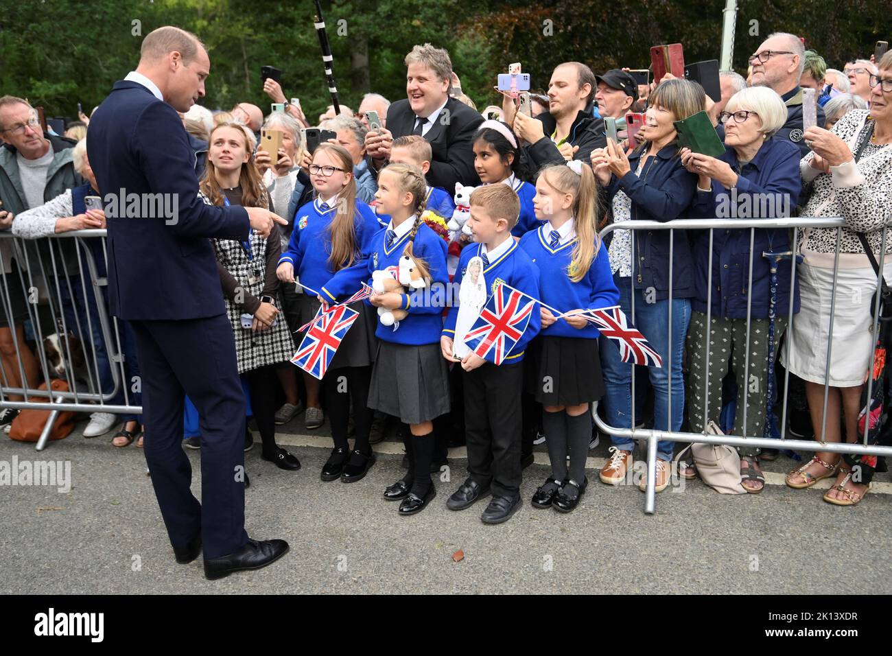 The Prince of Wales meeting students from Howard Junior School in King's Lynn as he views floral tributes left by members of the public at the gates of Sandringham House in Norfolk, following the death of Queen Elizabeth II. Picture date: Thursday September 15, 2022. Stock Photo