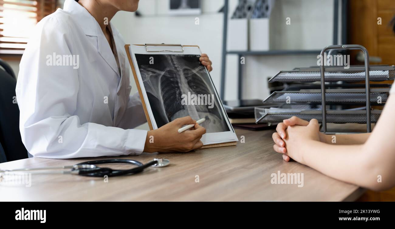 Doctor showing x-ray result to patient in clinic Stock Photo