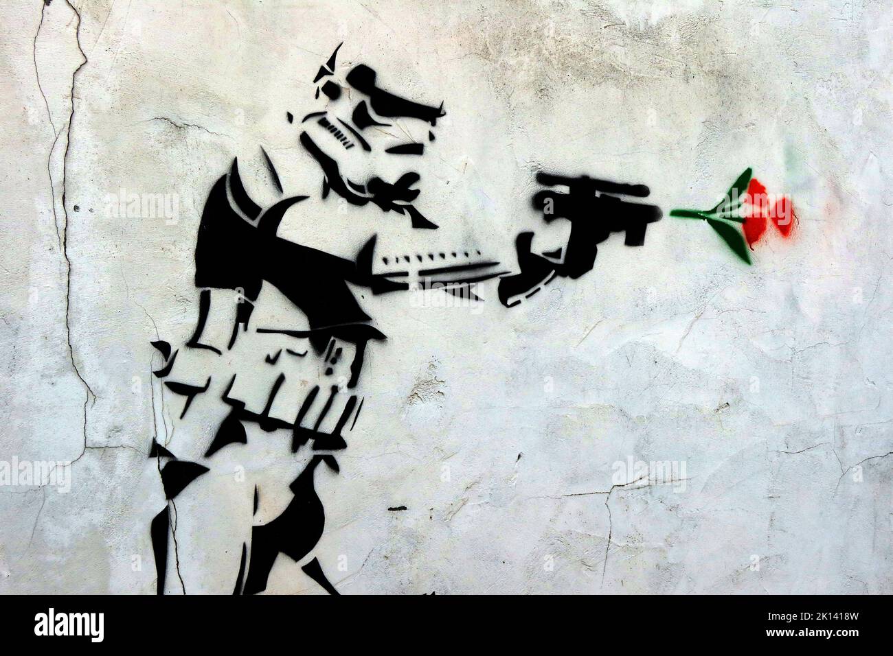 Stormtrooper fires a gun and a red rose comes out, stencil art in Church Street, Runcorn, Halton, Cheshire, England, UK, WA7 1LR Stock Photo