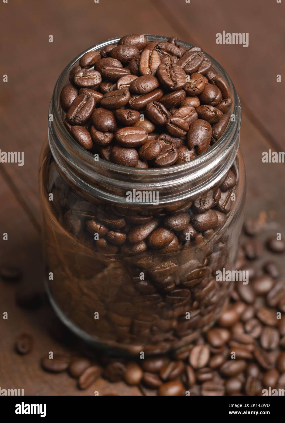Coffee beans in glass mason jar on wood Stock Photo