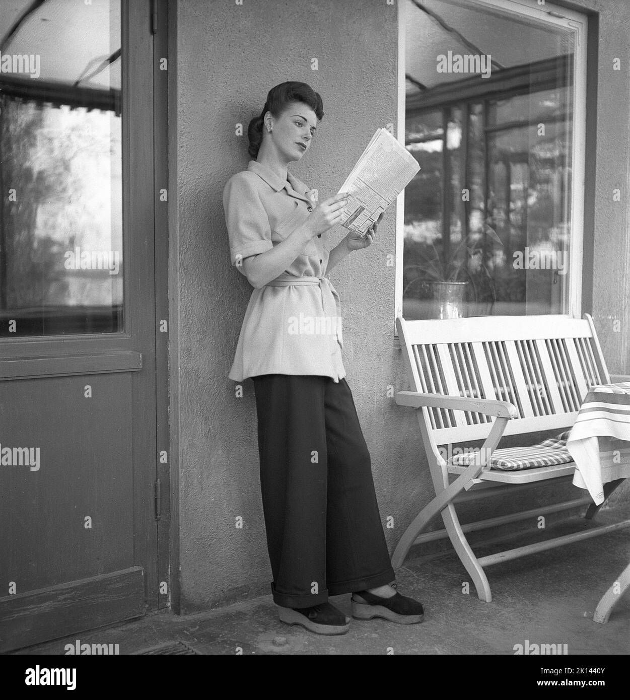 Women's fashion in the 1940s. A young woman photographed for a ladies magazine to show the women's fashion of 1945. The female model is wearing wide legged trousers and a short coat or jacket.  Sweden 1945.  Kristoffersson Ref R5-2 Stock Photo