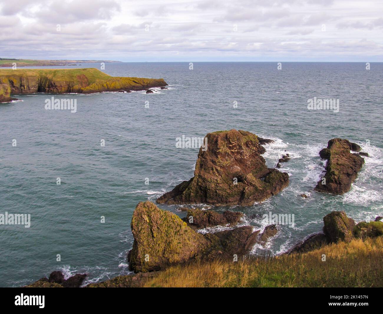 View over the North Sea with the cliffs of the rugged Scottish coastline in the foreground. The Coastal route along the North-Eastern Scottish coast i Stock Photo