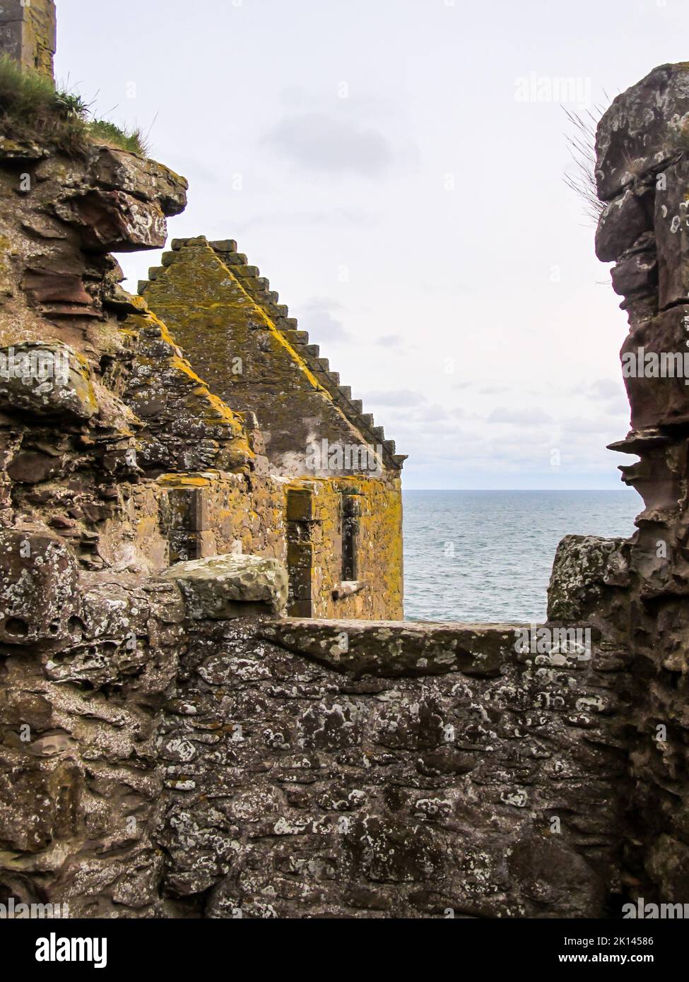 Looking through the broken walls of the ruins of Dunnotar Castle, in Scotland, towards the North Sea Stock Photo