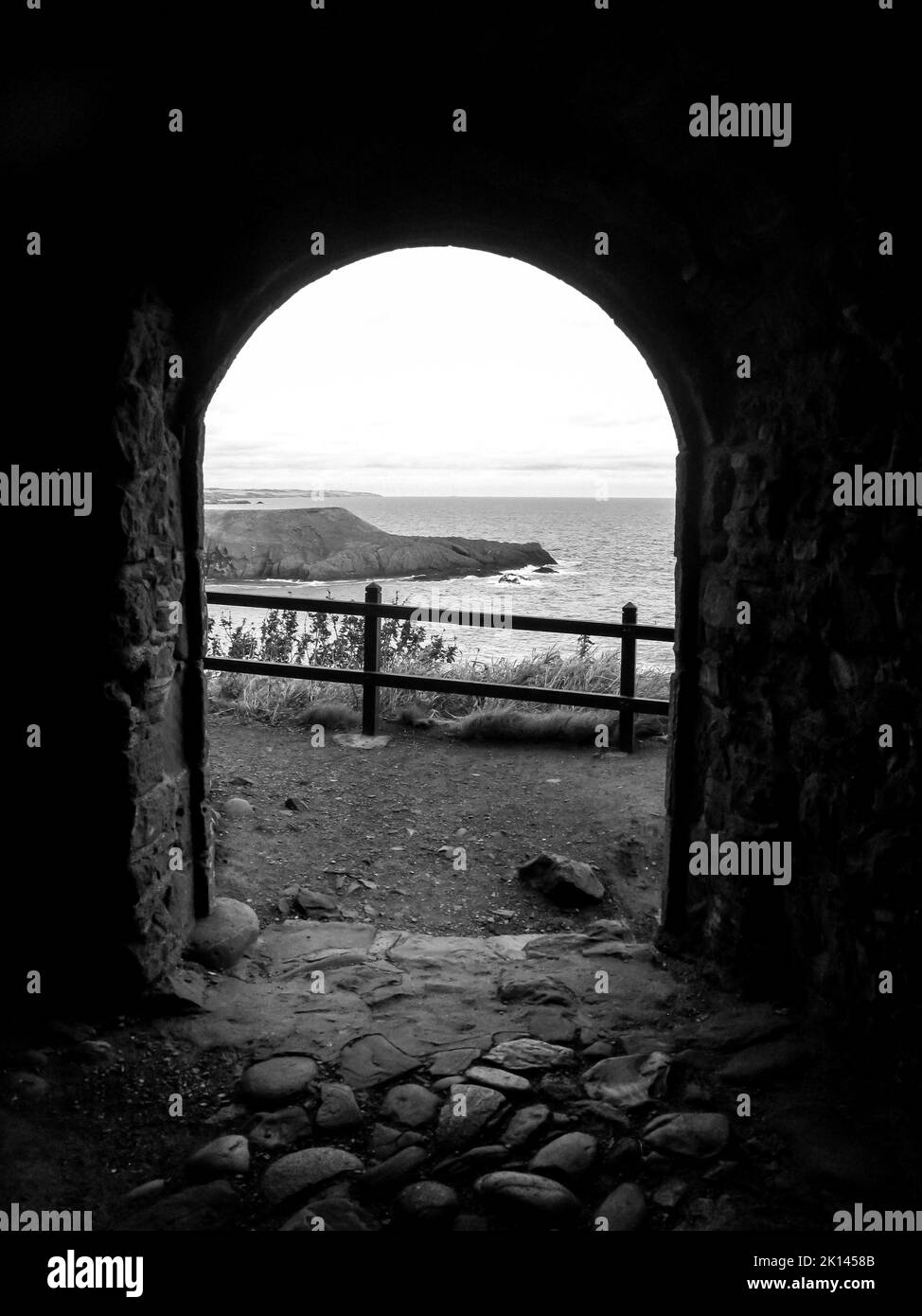 Looking through an old doorway towards Scotland’s North Sea coast, in Black and White. Stock Photo