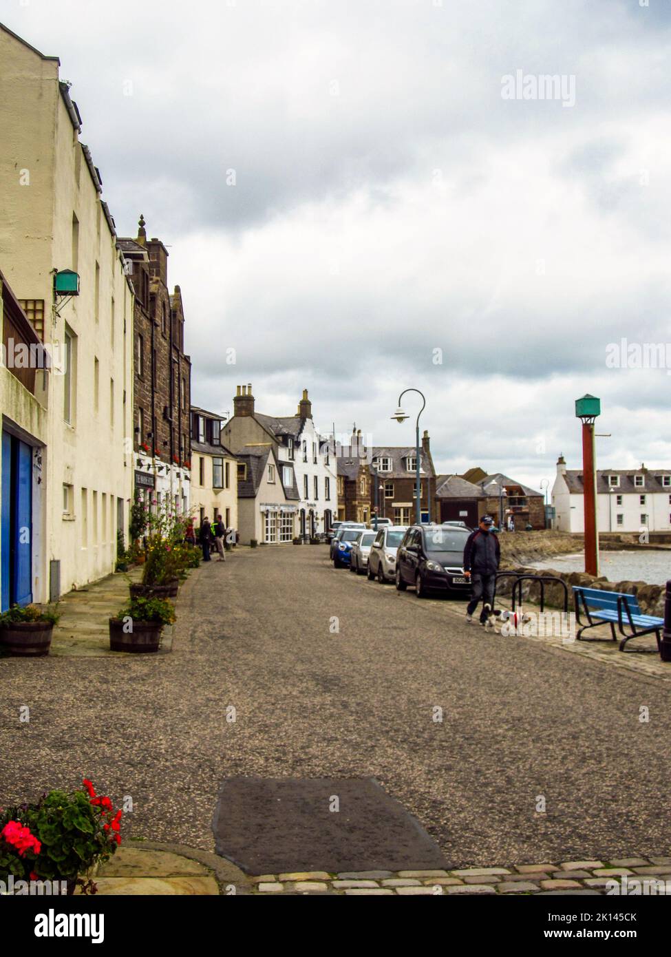 Cobblestone road in the morning, at the harbor of the small Scottish fishing village of Stonehaven. Stonehaven, is a Scottish coastal town which grew Stock Photo