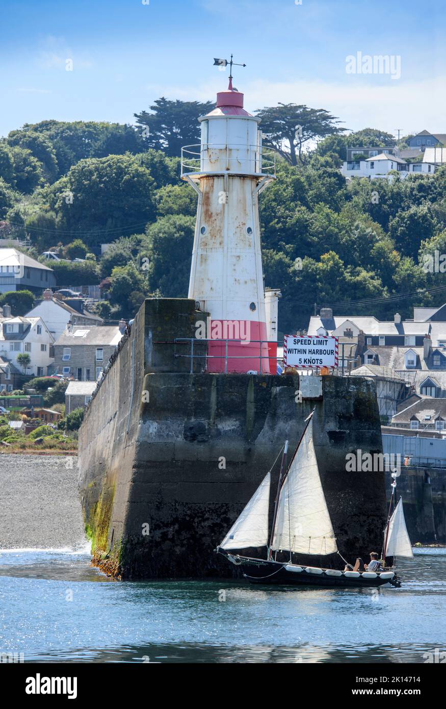 A sailing boat leaves Newlyn harbour in Cornwall, UK - the mean sea level at Newlyn, Ordnance Datum Newlyn provides the vertical datum the Ordnance Su Stock Photo
