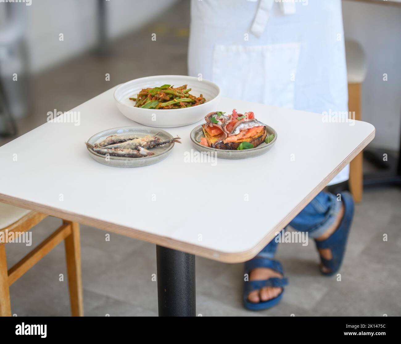 Three dishes presented in a simple dining room. Stock Photo