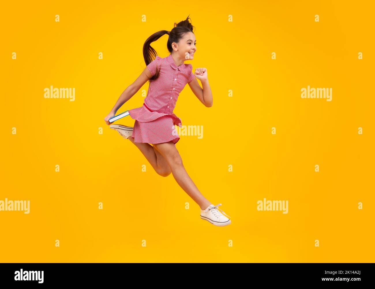 Schoolgirl with copy book posing on isolated background. Literature lesson, grammar school
