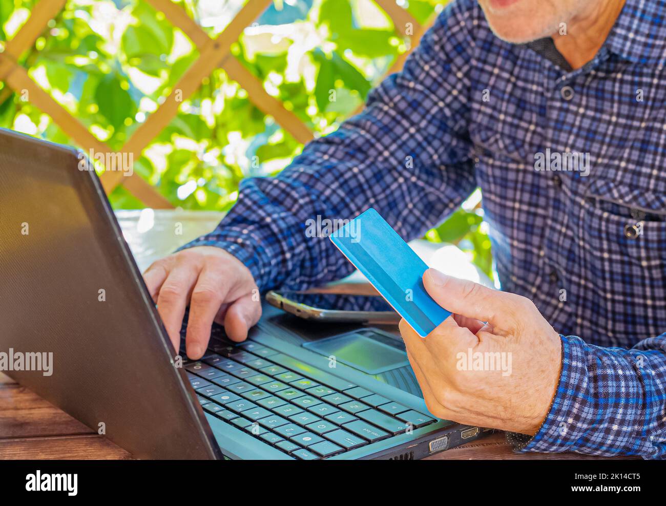 Person laptop credit card. Collateral deal. Internet technologies. Online payment, security. Online banking. Stock Photo