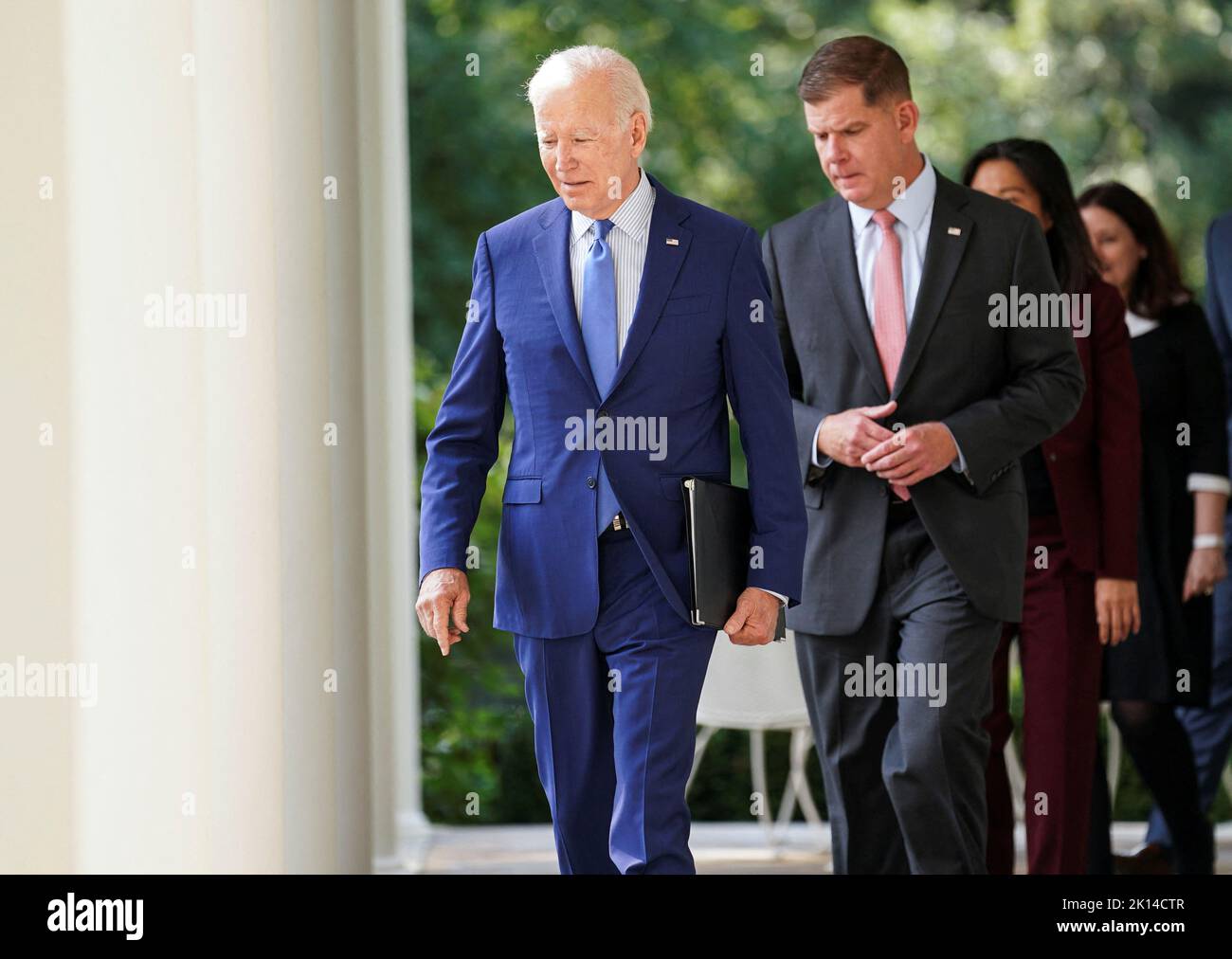 U.S. President Joe Biden walks with Labor Secretary Marty Walsh and negotiators who brokered the railway labor agreement after U.S. railroads and unions secured a tentative deal to avert a rail shutdown, as he arrives to deliver remarks on the deal in the Rose Garden at the White House in Washington, U.S., September 15, 2022. REUTERS/Kevin Lamarque Stock Photo