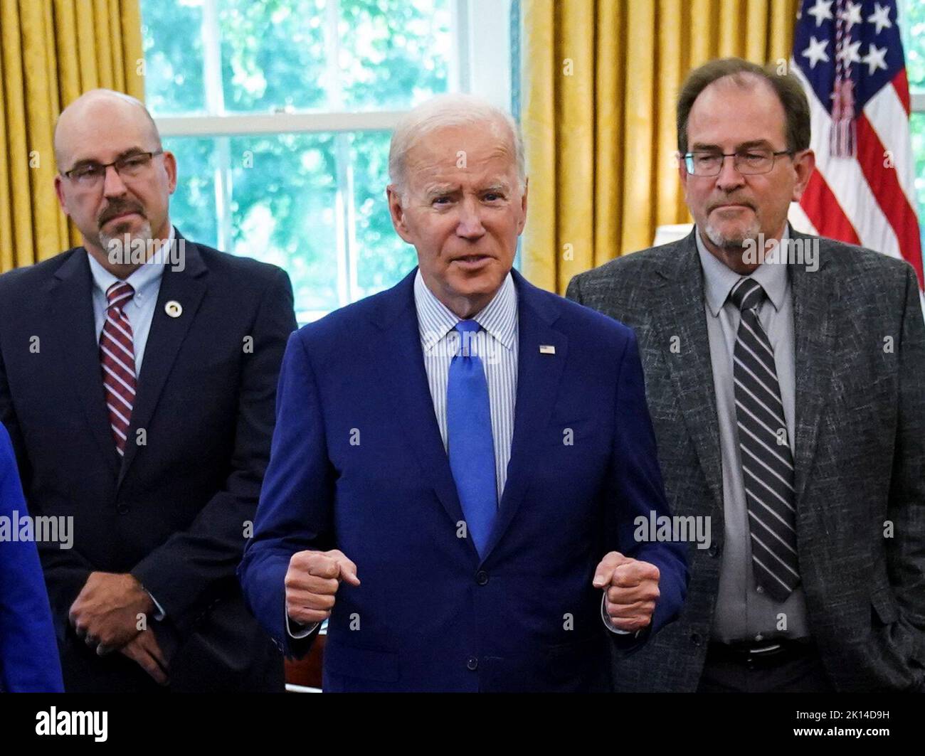 U.S. President Joe Biden pumps his fists as he greets negotiators who brokered the railway labor agreement after U.S. railroads and unions secured a tentative deal to avert a rail shutdown, in the Oval Office at the White House in Washington, U.S., September 15, 2022. REUTERS/Kevin Lamarque Stock Photo