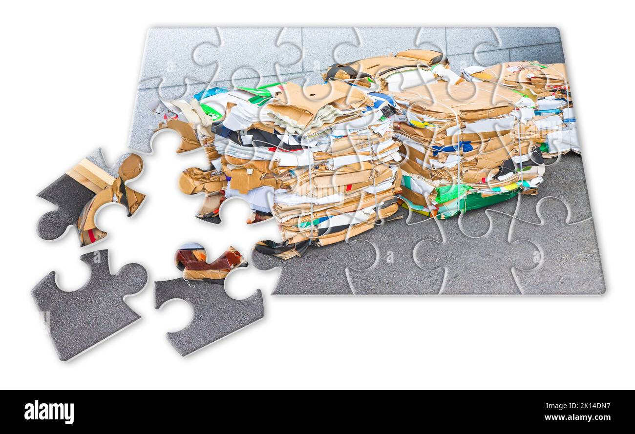 Learning to recycle - concept image in jigsaw puzzle shape - Stacks of paper and cardboard ready to be recycled Stock Photo
