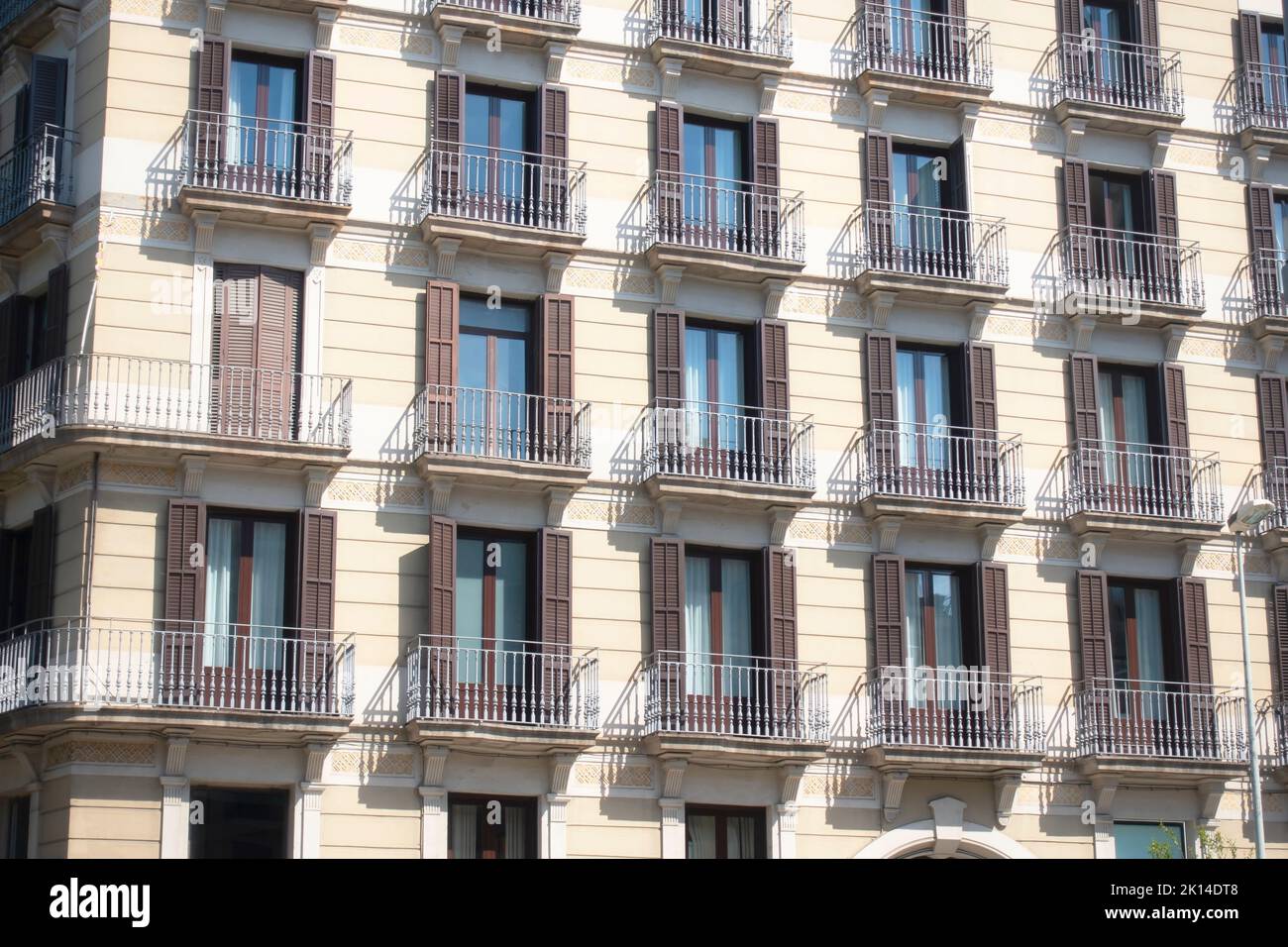 Barcelona, Spain May 9, 2022 Facade of an beige residential building in Barcelona. Stock Photo