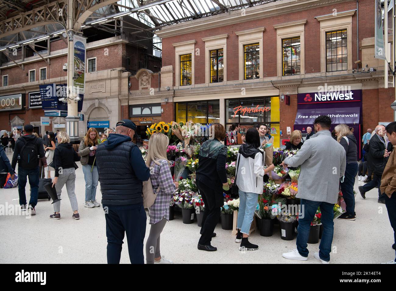 London, UK. 14th September, 2022. Mourners stop to buy flowers at a