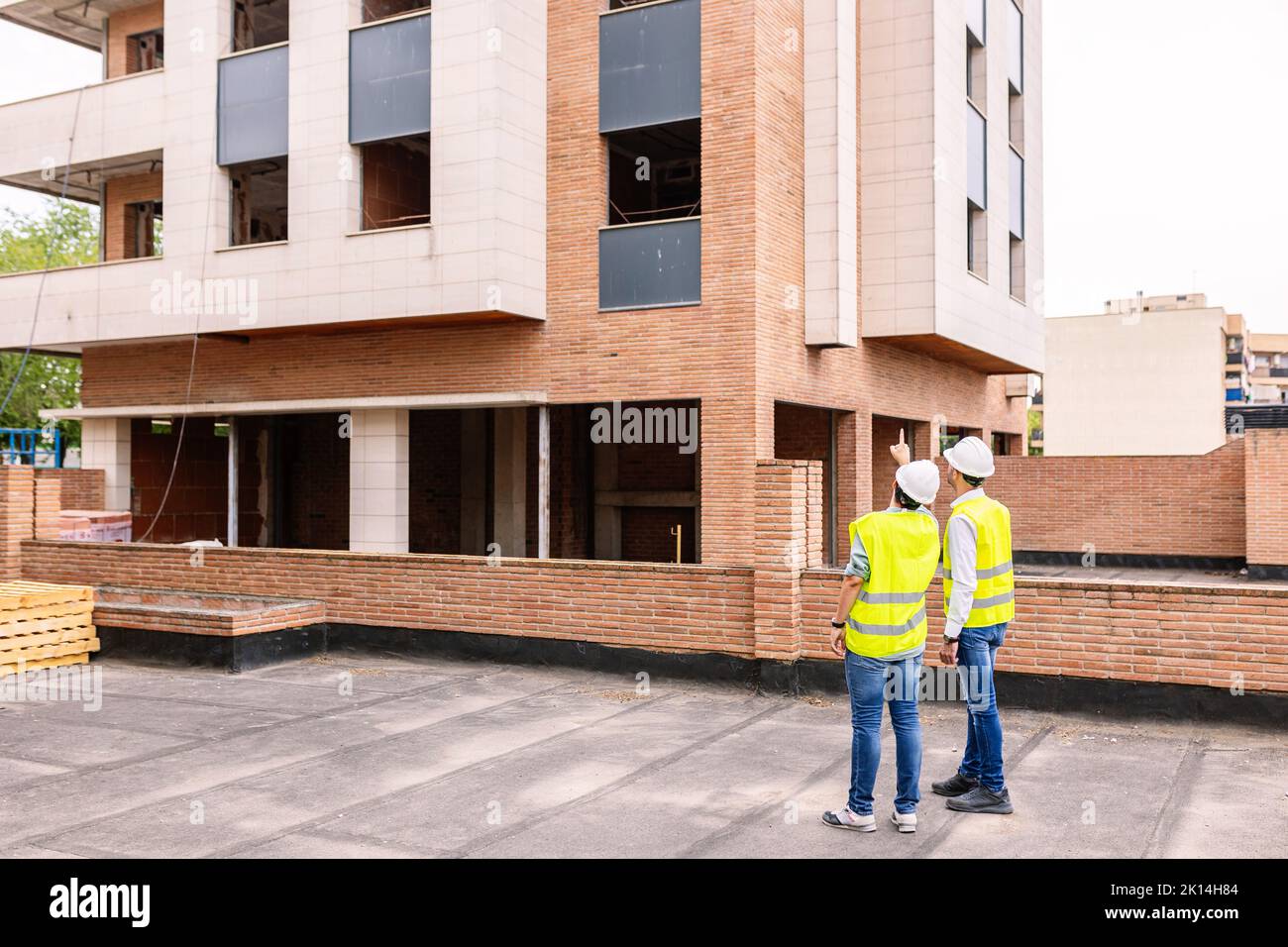 Professional engineers architect workers talking at building construction site Stock Photo
