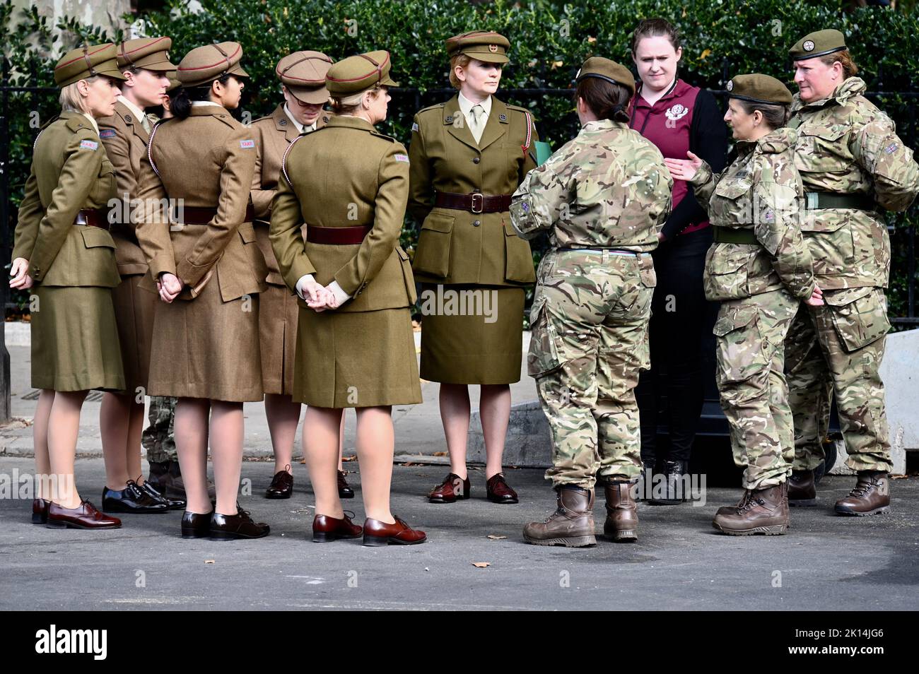 London, UK. Soldiers in modern kit met women dressed in vintage First Aid Nursing Yeomanry uniforms, in tribute to Queen Elizabeth who served in the Women's Auxiliary Territory Service during World War II. Houses of Parliament, Westminster. Credit: michael melia/Alamy Live News Stock Photo