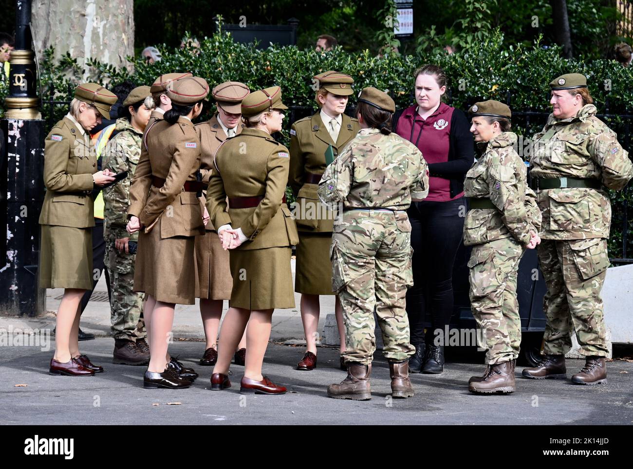 London, UK. Soldiers in modern kit met women dressed in vintage First Aid Nursing Yeomanry uniforms, in tribute to Queen Elizabeth who served in the Women's Auxiliary Territory Service during World War II. Houses of Parliament, Westminster. Credit: michael melia/Alamy Live News Stock Photo
