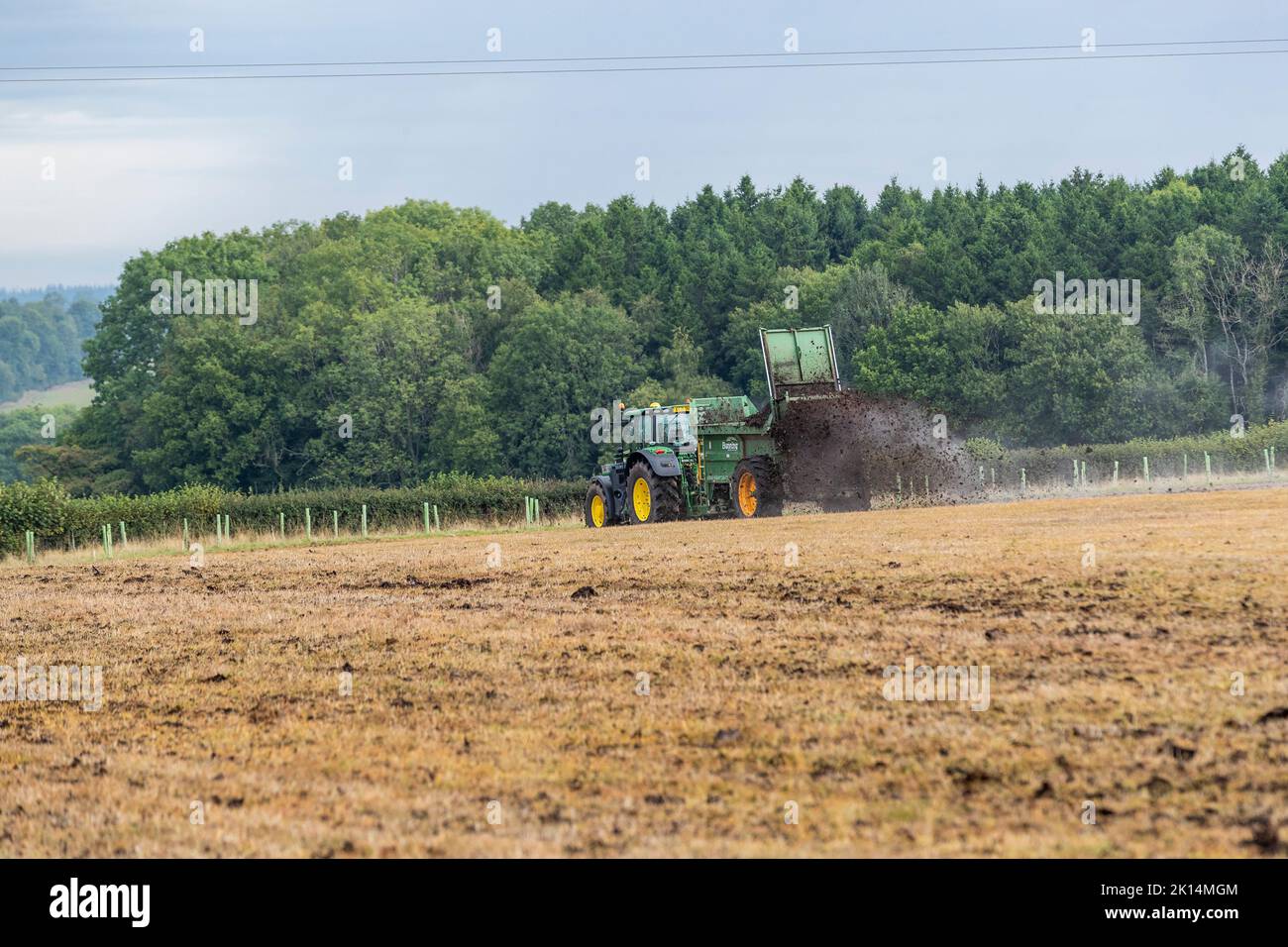 Modern agriculture. Muck spreading prior to ploughing Stock Photo Alamy