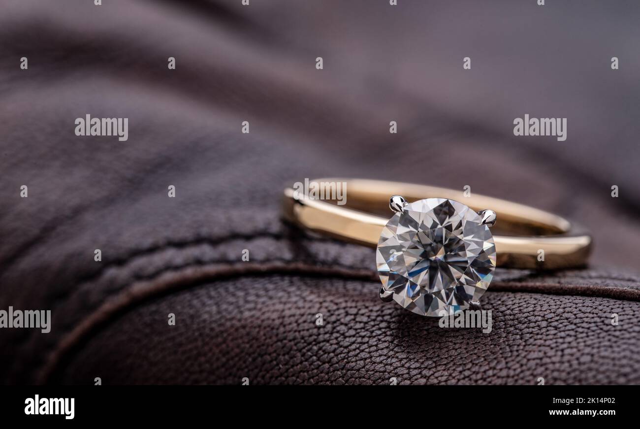Solitaire Wedding Ring With Round Cut Diamond on Brown Leather Stock Photo