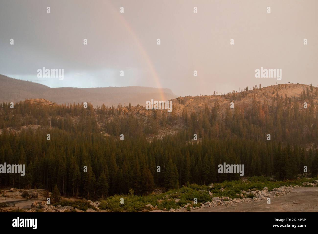 Thunderstorms in Yosemite National Park, like this one near Tenaya Lake and Olmsted Point, sometimes product rainbows. Stock Photo