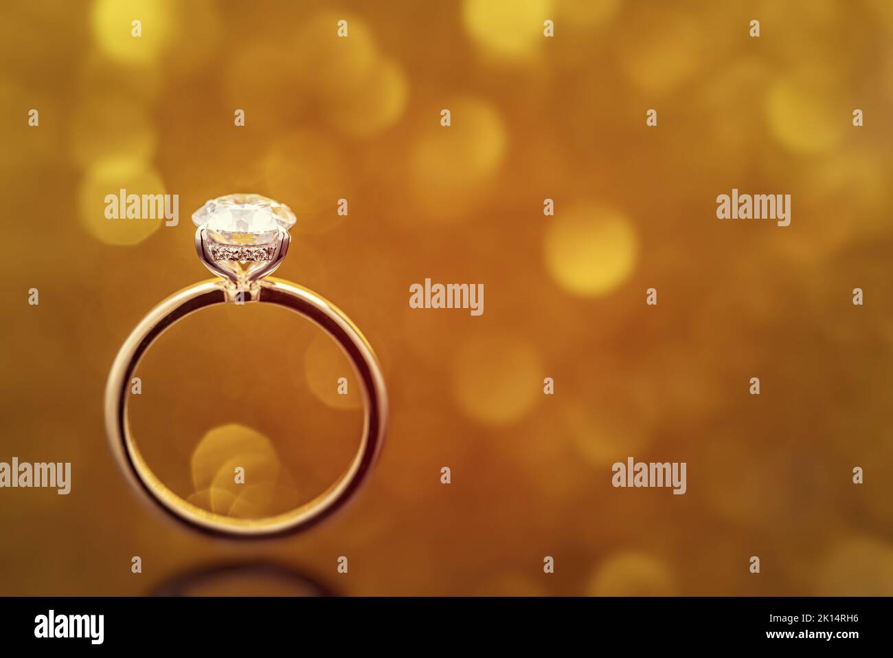 Engagement Diamond Ring on Golden Light Bokeh Background Stock Photo ...