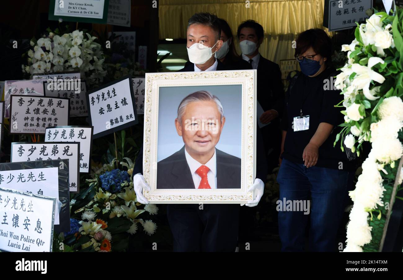 Glen Lee Lamyan holds his father Ambrose Lee Siukwong's portrait at