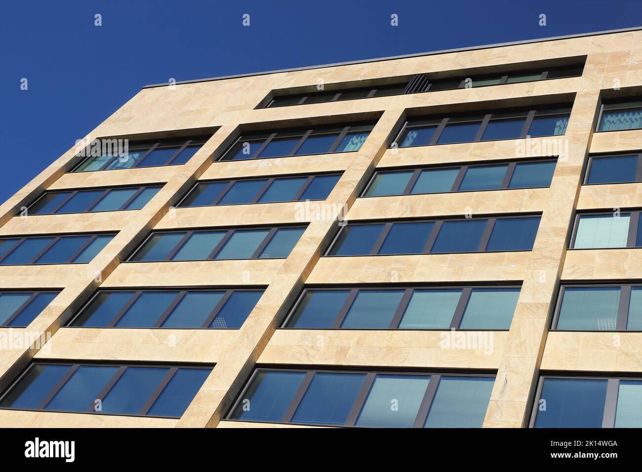 Detail view of an office building facade with windows seen from a low angle. Stock Photo