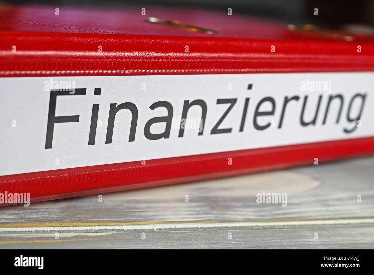 Closeup of isolated red file folder with german word Finanzierung (engl. Translation: financing), euro money banknotes Stock Photo