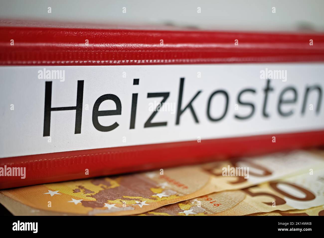 Closeup of isolated red file folder with german word Heizkosten (engl