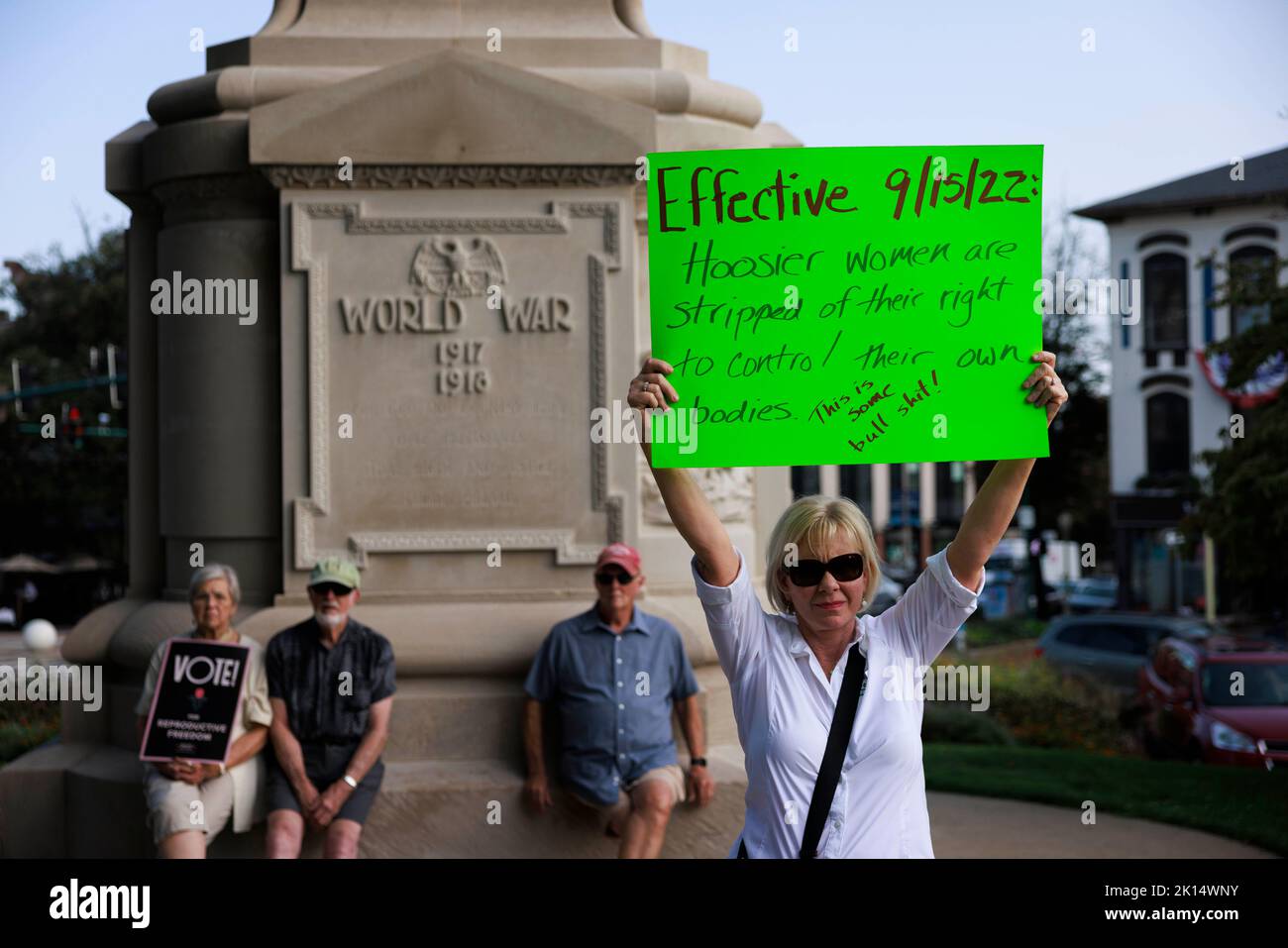 BLOOMINGTON, INDIANA - SEPTEMBER 14: (EDITORS NOTE: Image contains profanity.) Abortion rights activist holds a sign reading, 'Effective 9/15/22 Hoosier women are stripped of their right to control their own babies (This is some bullsh*t)' at the Monroe County Courthouse during a protest vigil a few hours before Indiana’s near total abortion ban goes into effect, on September 14, 2022 in Bloomington, Indiana. The Indiana legislature passed a law August 5th banning abortion in most cases, and making Indiana the first state to pass such a law after the Supreme Court’s conservative majority stuck Stock Photo