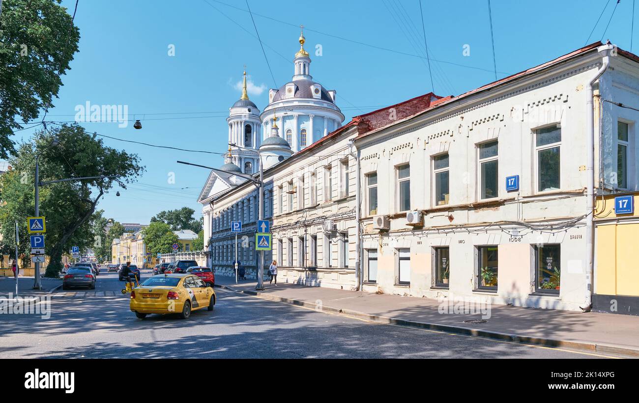 View of two story 19th century houses and the Church of Martin the Confessor by architect R.R. Kazakov, Alexander Solzhenitsyn Street, landmark: Mosco Stock Photo