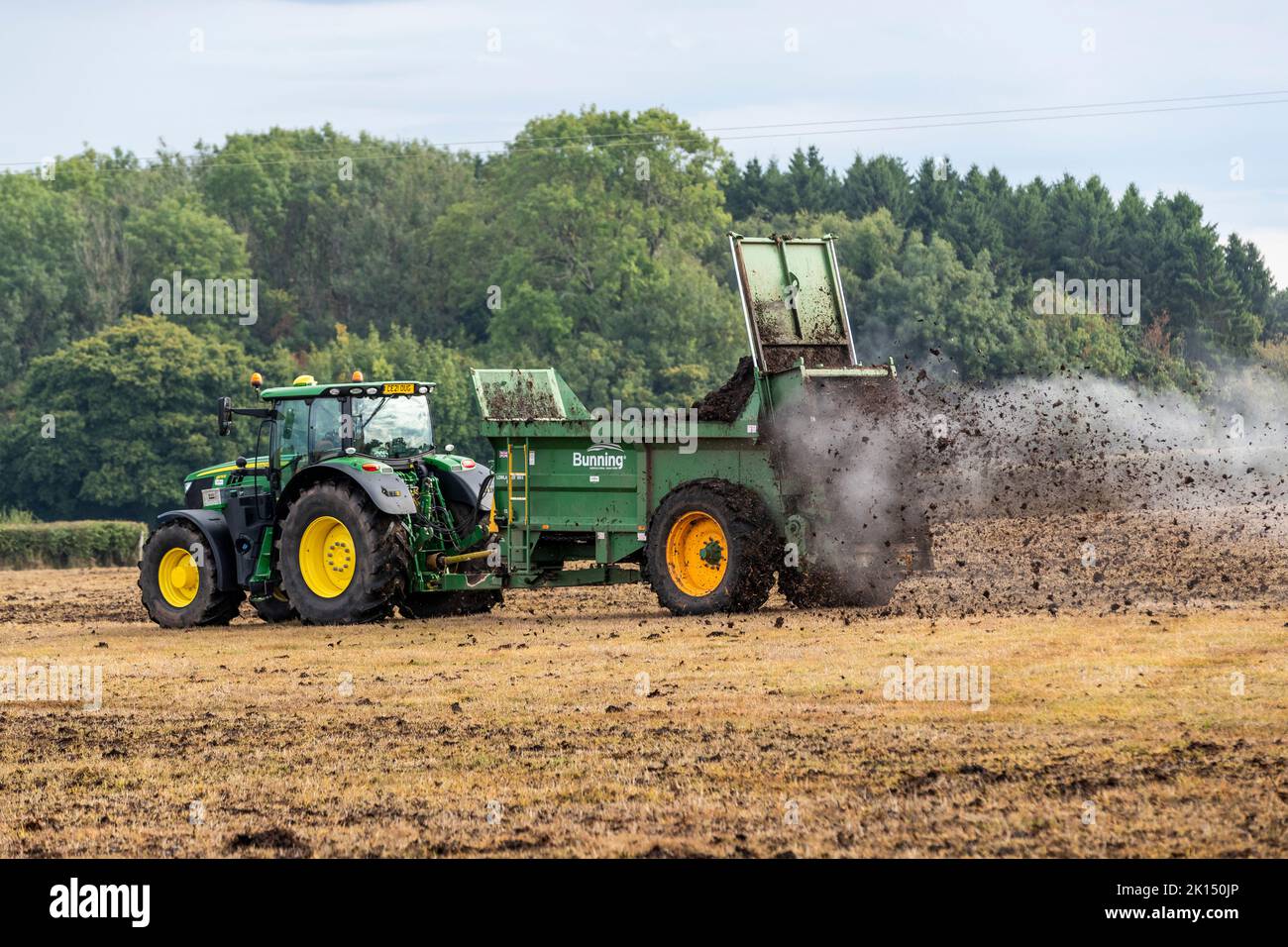 Modern agriculture. Muck spreading prior to ploughing Stock Photo Alamy