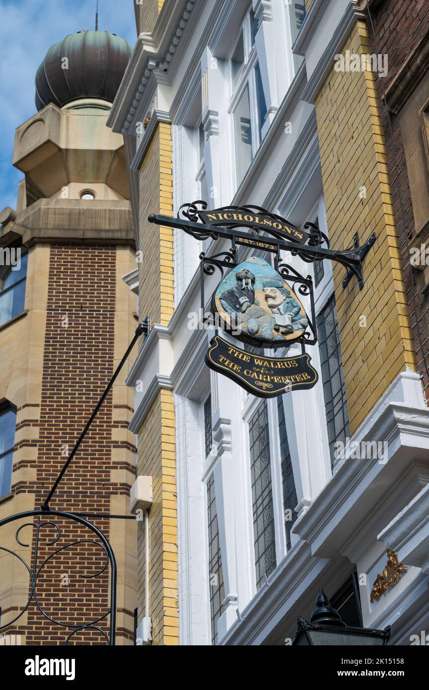 Pub sign for The Walrus and the Carpenter public house situated on the corner of Monument Street and Lovat Lane. City of London, England, UK Stock Photo