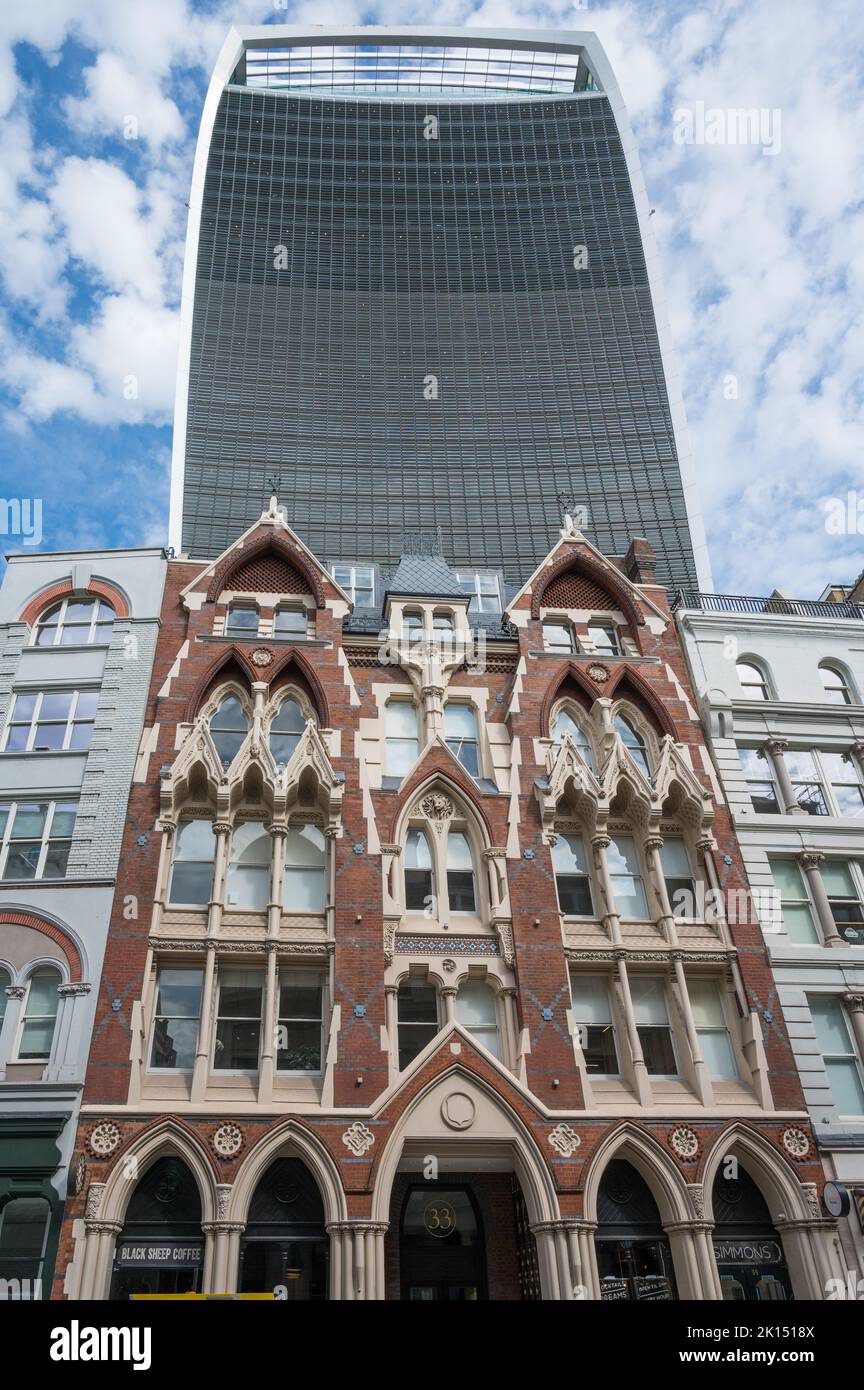 The Fenchurch Building, aka the Walkie Talkie, looms over the Gothic style grade ll listed building at 35 Eastcheap, London, England, UK. Stock Photo