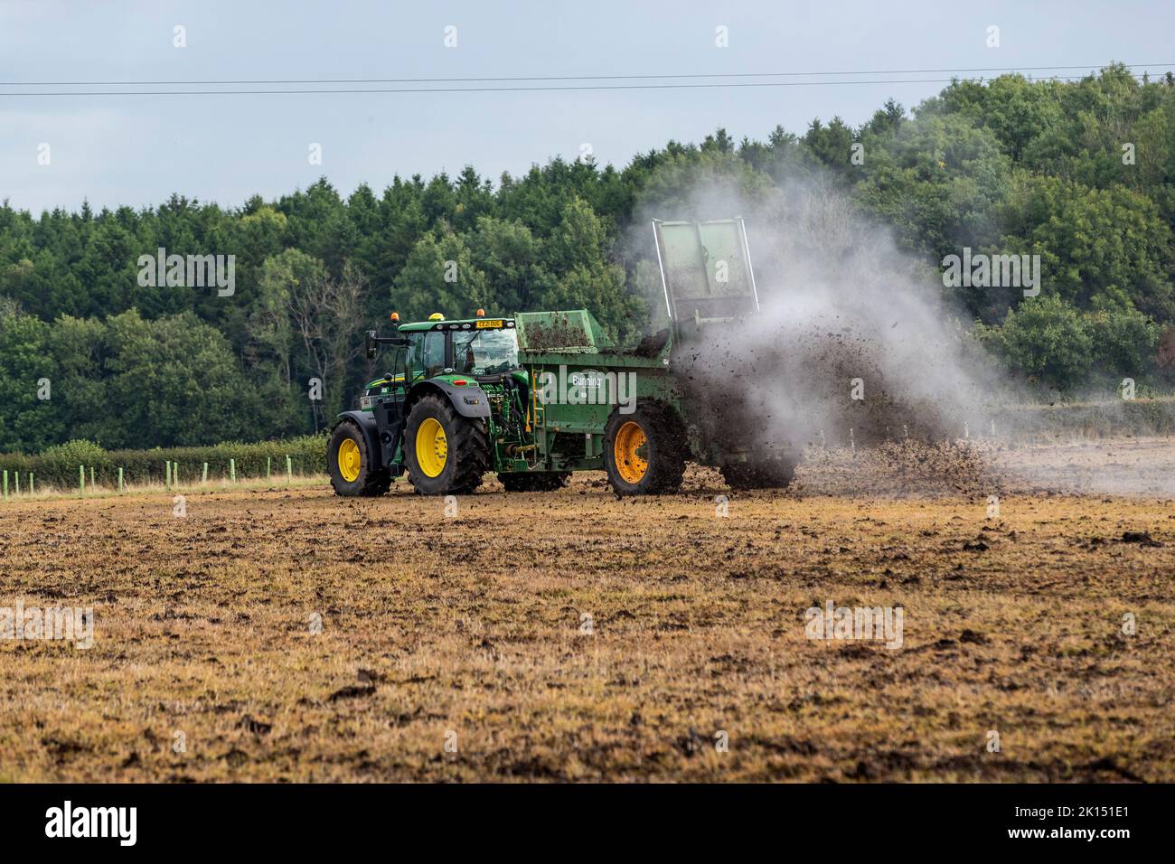 Modern agriculture. Muck spreading prior to ploughing Stock Photo Alamy