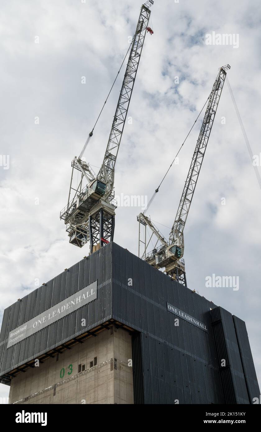 Tower cranes stand above the concrete core on the construction site for the new building at One Leadenhall. City of London, England, UK Stock Photo