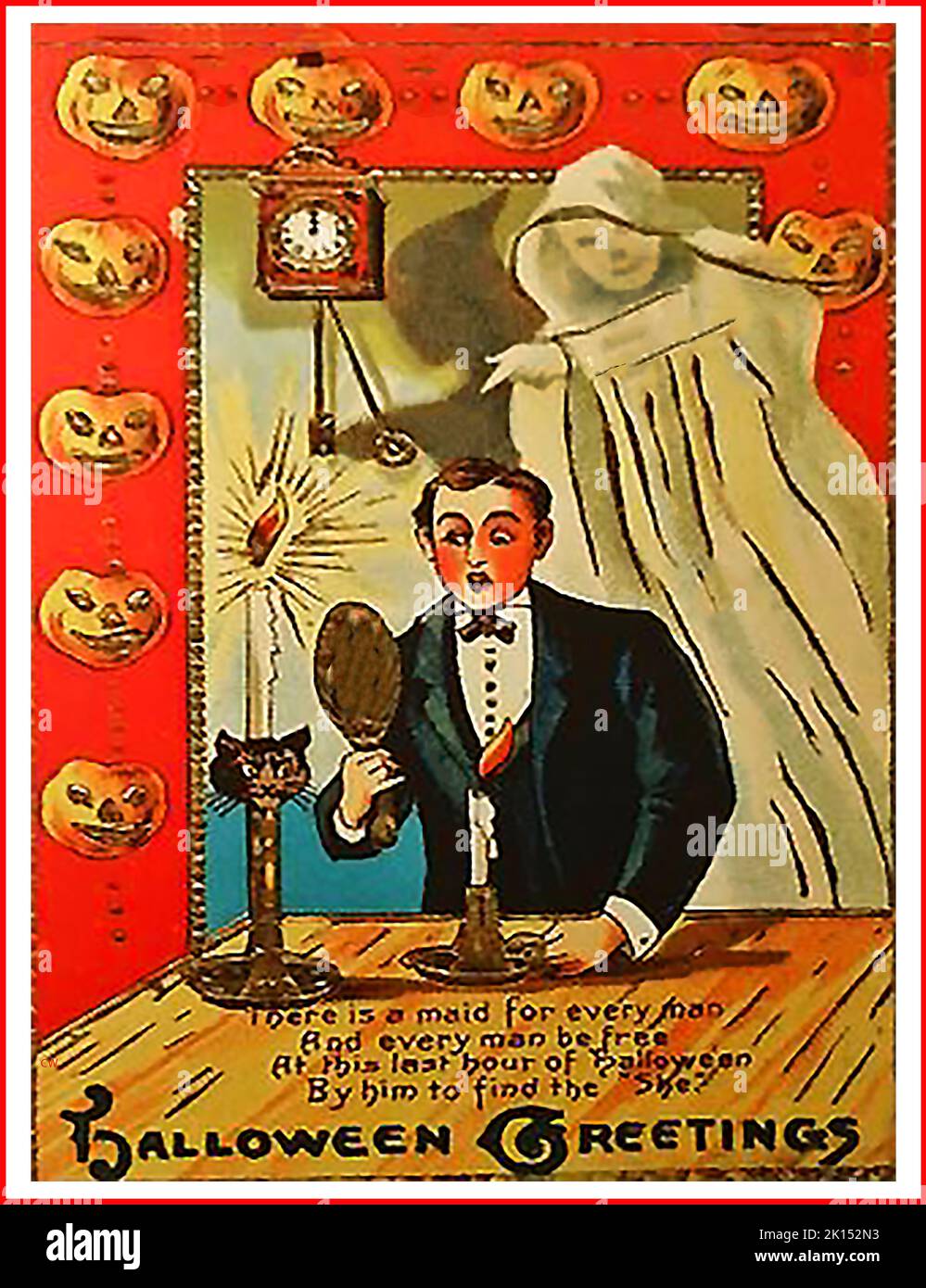 An old Halloween greetings card featuring a  ghost and a magic mirror which was supposed to reveal the face of the person someone would marry, if looked at during the final hour of Halloween Stock Photo