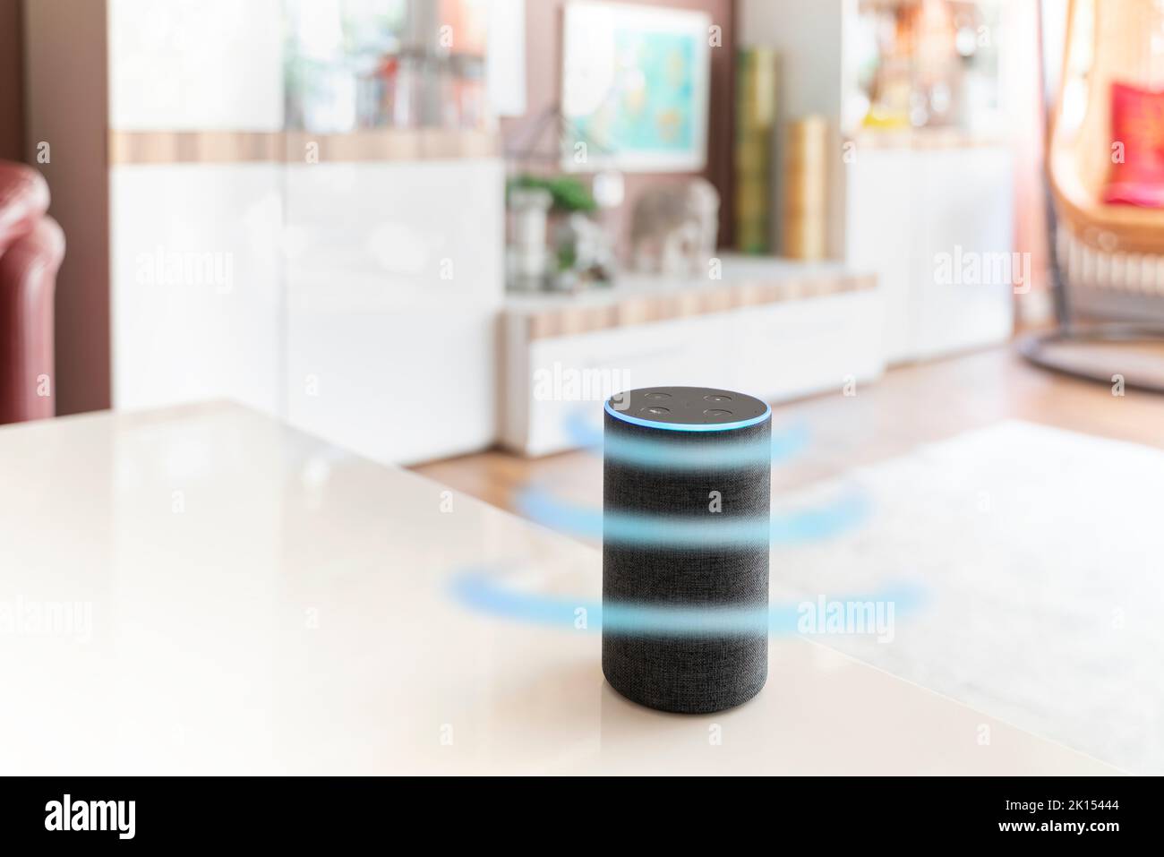 A smart speaker assistant stands in a bright living room. Light blue circles symbolize the expanding effect of microphone or remote control. Copy spac Stock Photo