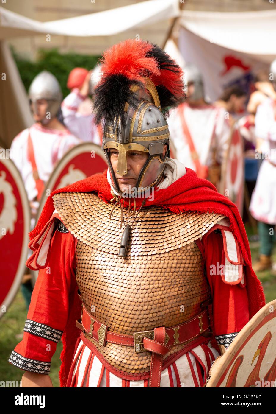 Roman warrior dressed in red and white at a reenactment of 4th Century Roman life during the 'Serdica is my Rome' heritage festival at the archaeologi Stock Photo