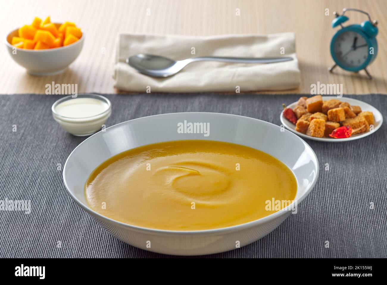 Pumpkin traditional soup with croutons and sour cream Stock Photo