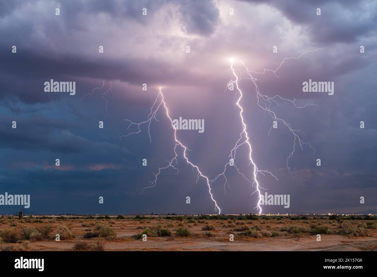 Dramatic lightning bolts strike in a thunderstorm over Casa Grande, Arizona Stock Photo