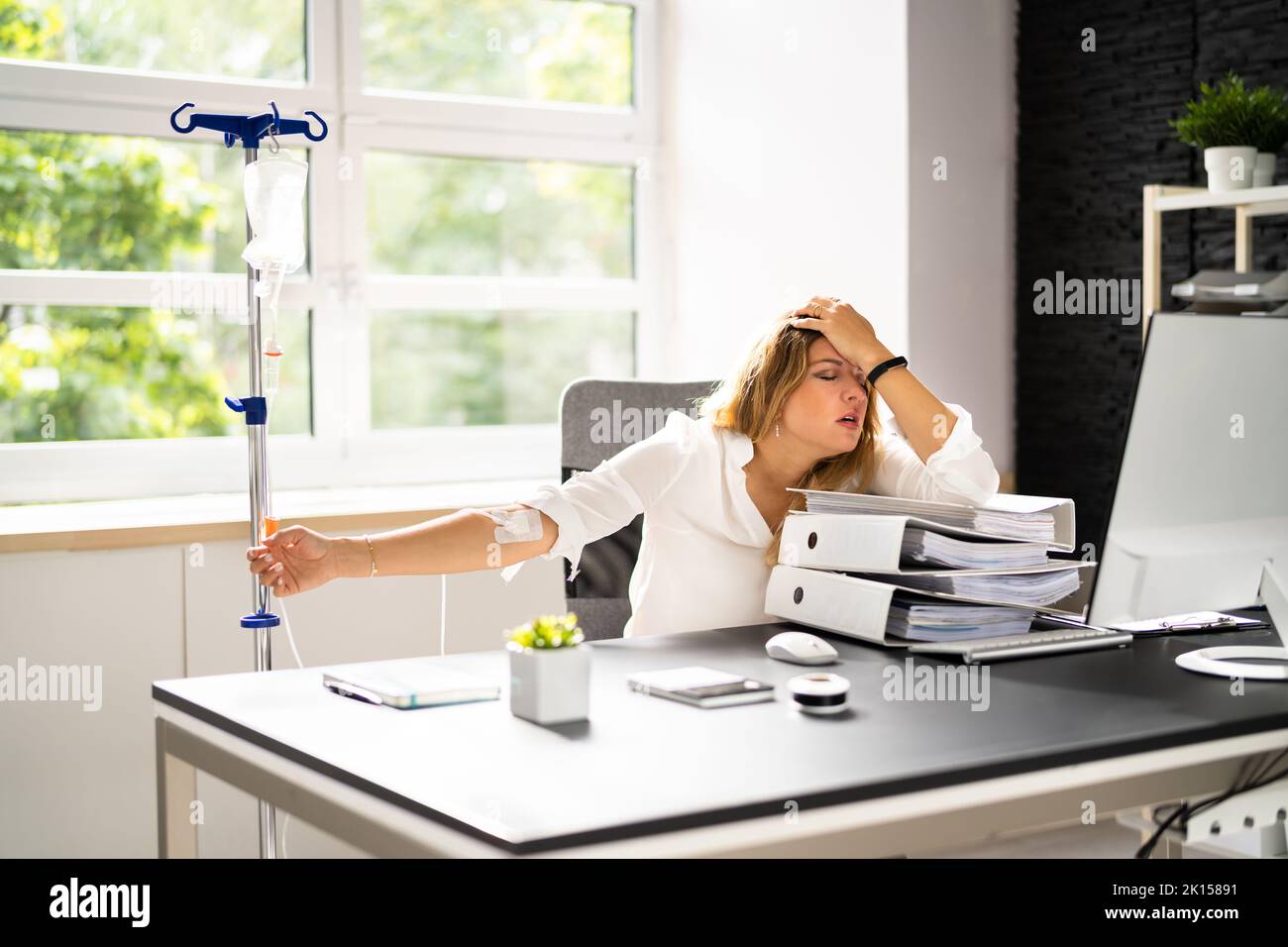 IV Drip Therapy In Office. Sick Woman Workload Stock Photo