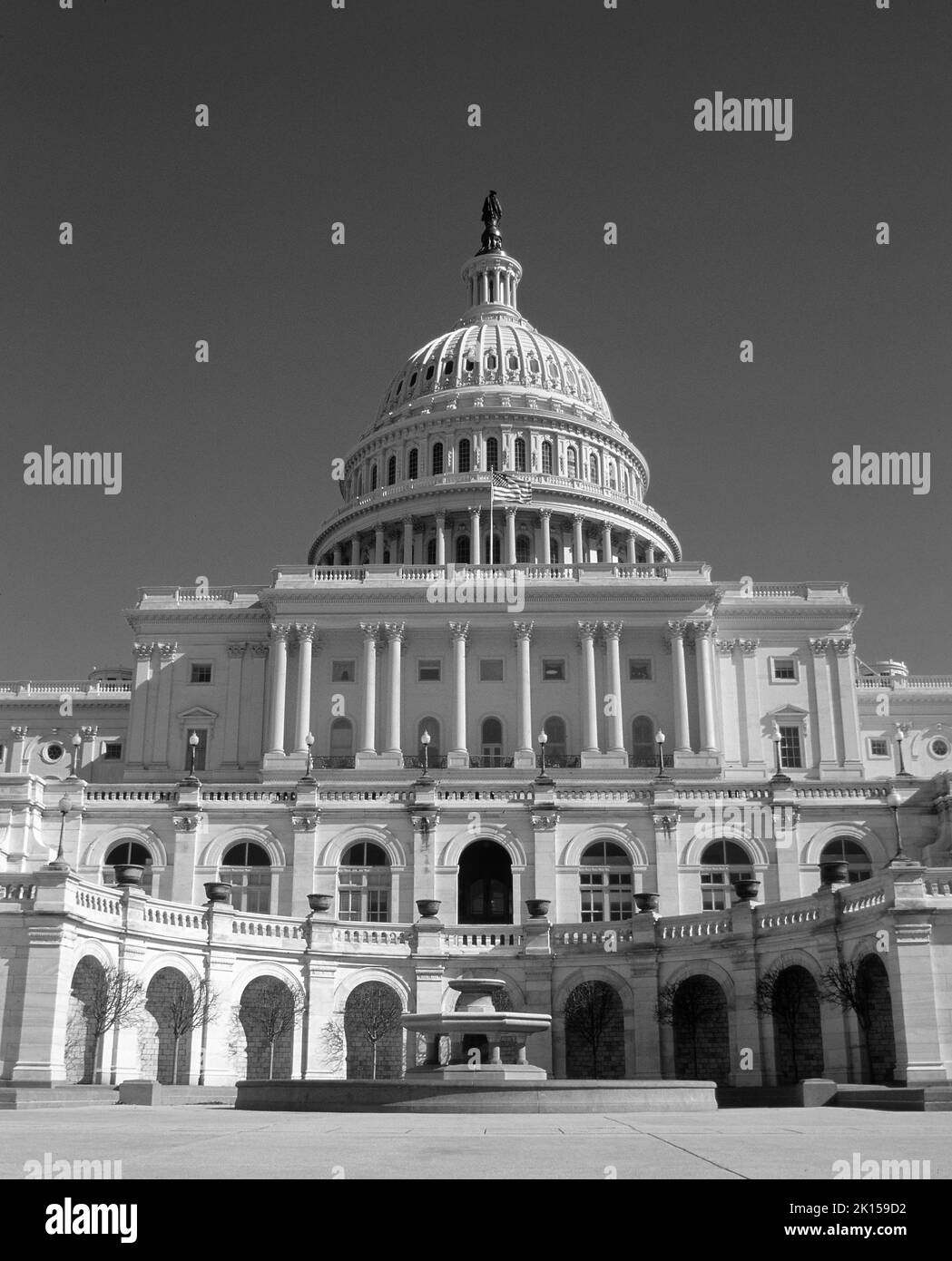 Black & White photograph of the US Capitol building with no people in Washington, D.C., District of Columbia, cloudless sky, Stock Photo